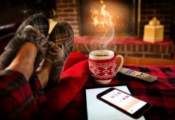 Image of someone relaxing in front of a fireplace